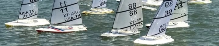 Several RC Laser sailboats racing